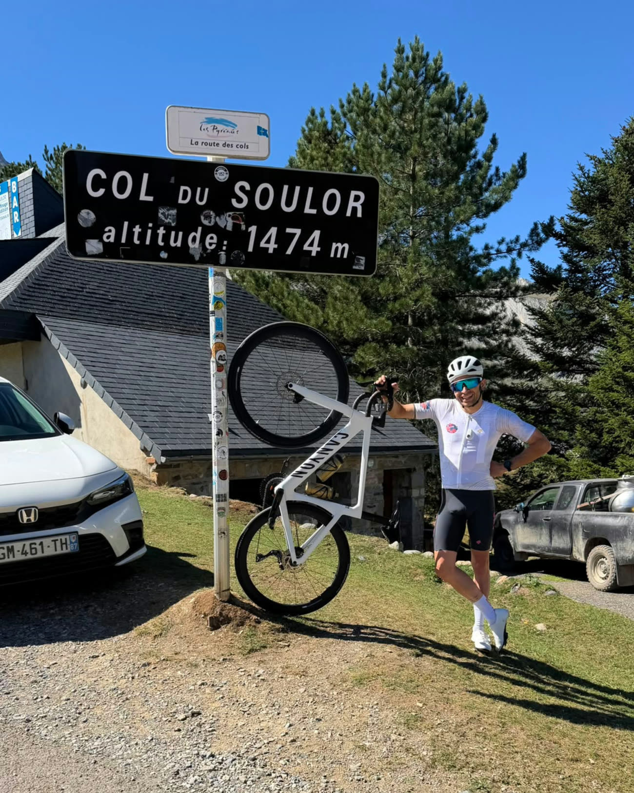Rodrigo with his bike at the Col du Soulor summit sign