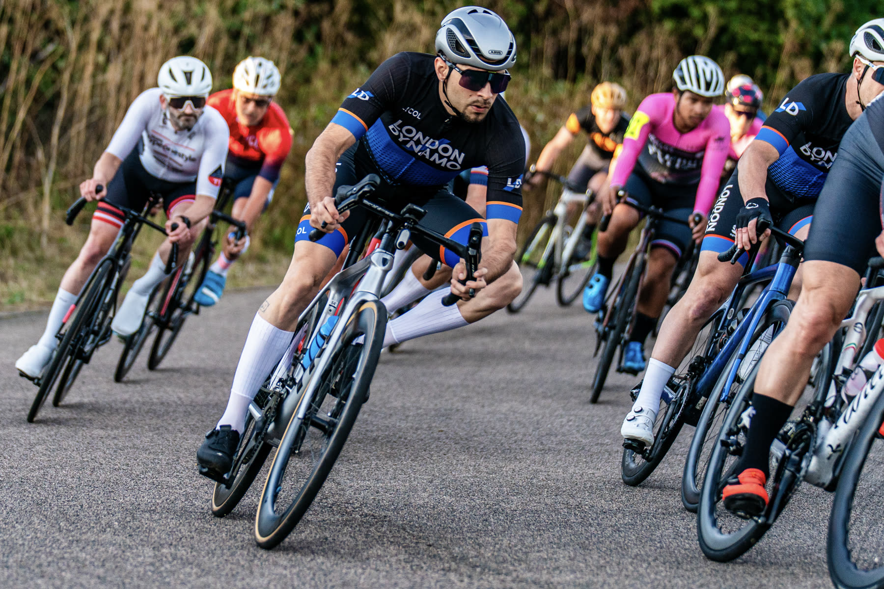Rodrigo cornering at the front of a criterium bunch in London Dynamo kit